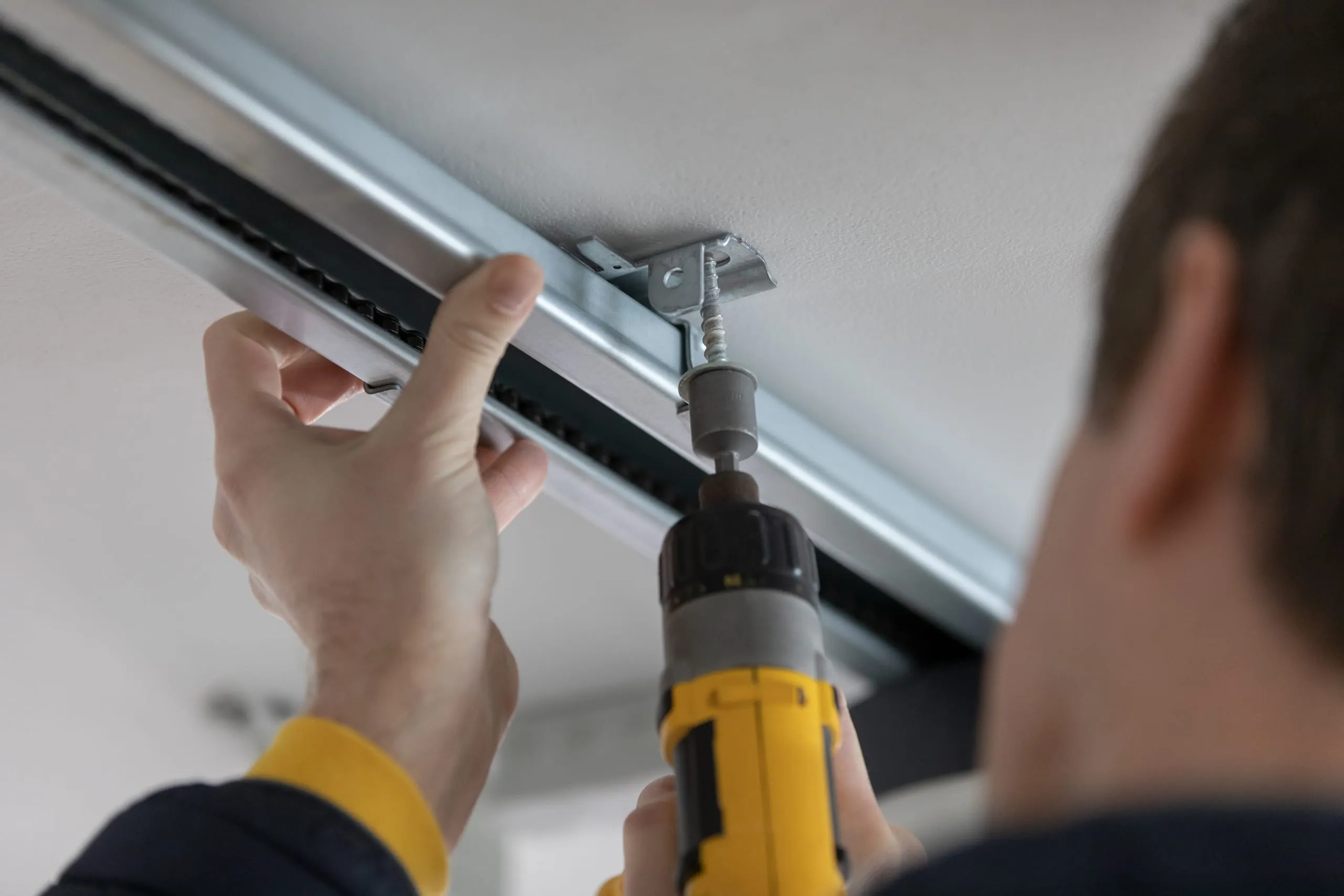 Montieren Sie den Antrieb und die Schienen an der Decke.