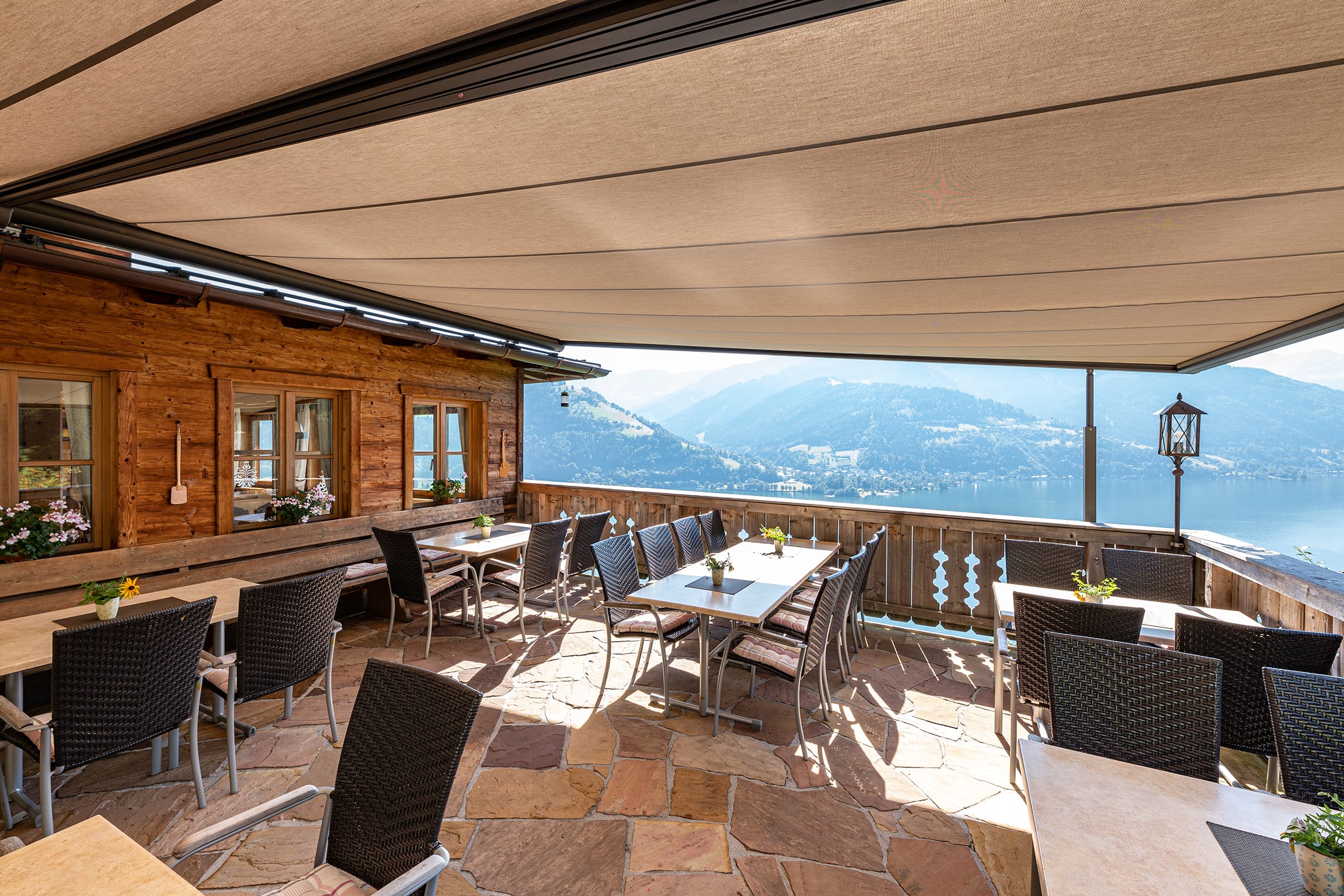 Die Jausenstation Pfefferbauer liegt idyllisch oberhalb des Zeller Sees im Salzburger Land. Die Außenterrasse bietet einen beeindruckenden Blick auf den See und die umliegenden Berge der Hohen Tauern. Dieses schöne Alpenpanorama sollten die Gäste möglichst lange im Jahr genießen können. So entschieden sich die Gastronomen, ein hochwertiges, dezentes Markisensystem von Markilux auf der Terrasse installieren zu lassen.