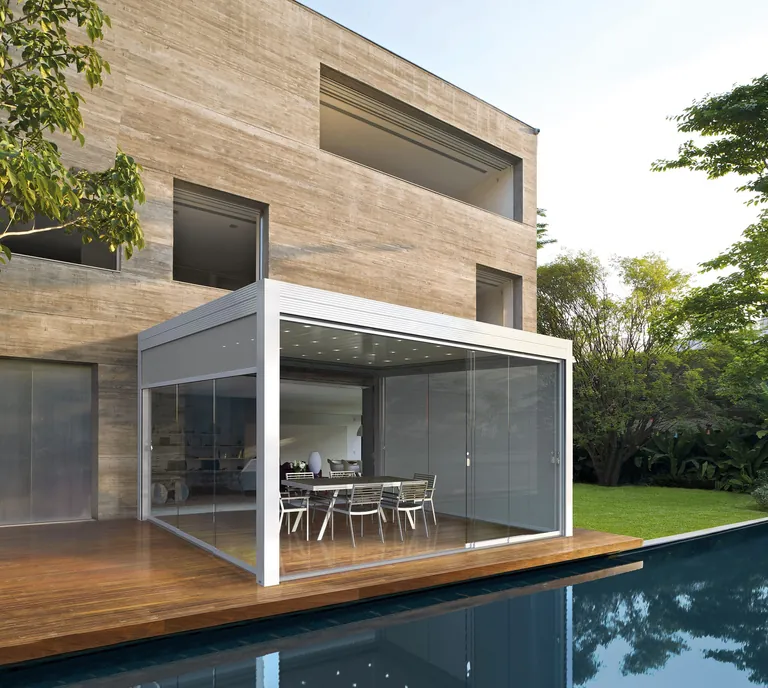 Das Varia Lamellendach ist eine vielseitige bioklimatische Pergola, die per Fernsteuerung über die Gibus Connect-Technologie bedienbar und mit integrierten seitlichen Abschlüssen ausgestattet ist.