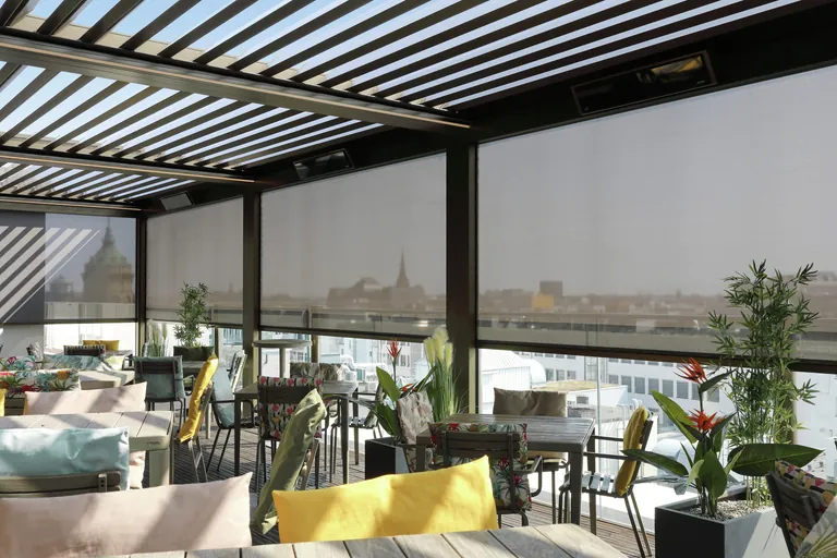 Seitliche Vorbau-Markisen mit easyZip-Führung sorgen auf der Dachterrasse für zusätzlichen Schutz bei tief stehender Sonne, Wind und Regen.
